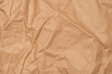 Craft wrapping paper texture of flat crumpled sheet of cellulose products. Old tattered page surface background. Eco-friendly empty aged recyclable packaging