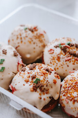 Donuts with white icing and colored sprinkles
