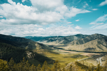 A stunning valley in the Altai Mountains is highlighted by rolling hills under expansive skies, capturing the essence of the region’s natural beauty