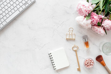 Office desktop mockup with peony flowers and female accessories, top view