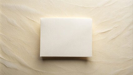 A crisp white square postcard with a blank face, awaiting personalized messages, set against a soft creamy background with subtle texture and gentle folds.