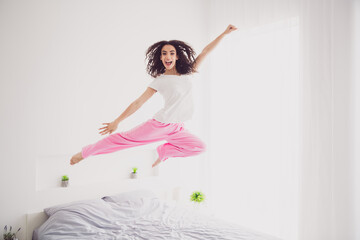 Full length photo of charming young woman jump flying superman good morning vibes awake home...