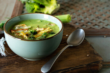bowl of creamy broccoli soup with chicken on the table