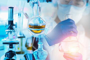 Research and development scientist with equipment and science experiments ,laboratory glassware containing chemical liquid for design or decorate science or other your content,selective focus.