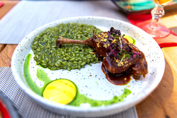 Duck leg with rice in demi-glace sauce