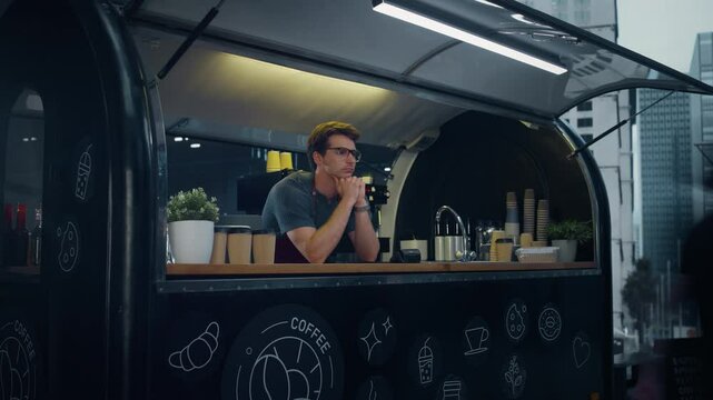 Timelapse Footage of a Sad and Tired Food Truck Worker Behind a Counter. Young Man Looking Around at Passing People. Nobody Stopping to Make an Order. City Life with Crowd in a Hurry to Get to Work