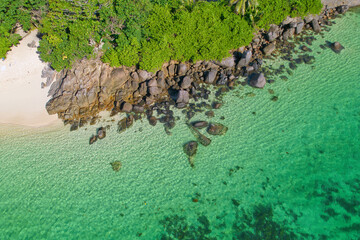 Drone aerial shot of Anse royale, fairy land of beautiful white sandy beach with granite stones and lush greenery, Mahe Seychelles