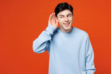 Young curious nosy happy Caucasian man wear blue sweatshirt casual clothes try to hear you overhear...