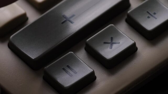 close up finger pressing calculator buttons, vintage push button calculator macro, accounting concept, budget and expense planning, financial reporting