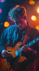 Obraz premium A vertical portrait of a musician playing a guitar on a dark stage, with the stage lights forming a colorful bokeh halo around them
