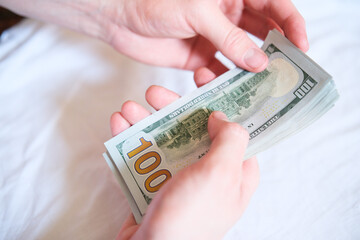 An Intimate CloseUp View of Hands Skillfully Counting Arrayed Dollar Bills of Cash