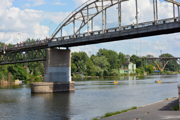 Beautiful view of the wide and long blue Dnipro River. Landscapes, a gray brick embankment with...