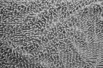 Processed image of fluffy gray doormat from bathroom in grey color