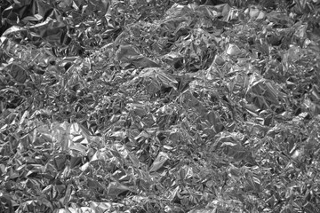 Processed collage of shiny metal silver gray foil crumpled packaging material texture