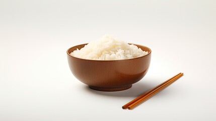 A Zen-like arrangement of chopsticks resting on a bed of perfectly cooked rice in a minimalist ceramic bowl.