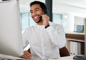 Man, happy and reading in call center by computer, headphones or mic for telemarketing in office....