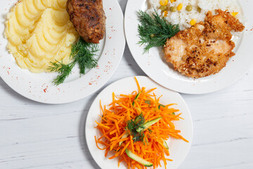 group photo of homemade food top view, salad, grilled chicken breast with rice, fried meat ball with mashed potato on a white wooden background