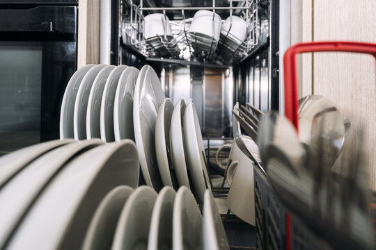 Deep focus on clean dishes in dishwasher, close up shot