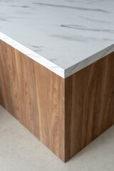 Modern wooden table with marble top in a minimalistic interior setting