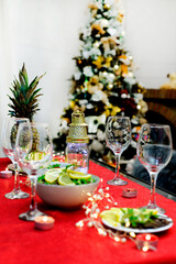 Festive table set for Christmas dinner,holiday decorations,fireplace,Christmas tree