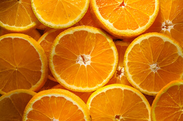 Colorful fresh orange fruit slices as background