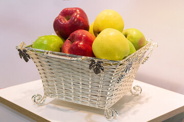 Fresh apples in a beautiful basket on the table