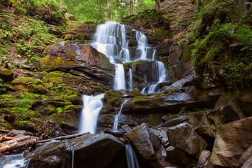 Obraz premium Amazing place in forest with floating waterfall. Wild nature in Ukrainian mountains.Place for text