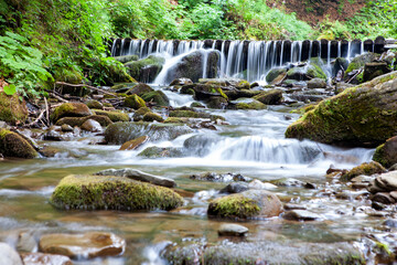 Amazing place in forest with floating waterfall. Wild nature in Ukrainian mountains.Place for text