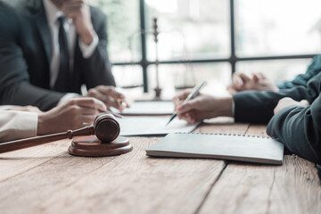Legal agreements or financial reports while reading and taking notes A team of lawyers works and...