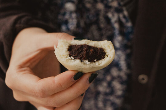 holding a bitten anko mochi