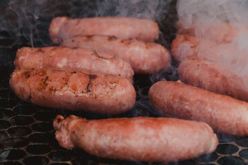sausages being grilled on the barbecue