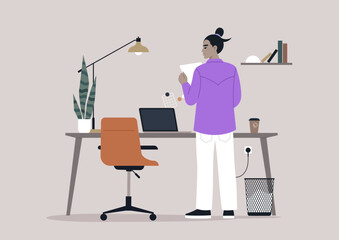 An individual in a purple shirt thoughtfully reviews a document while standing by a stylish desk in a contemporary office