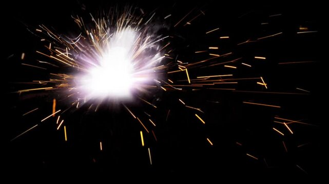 bright sparks of fire while welding on a dark background