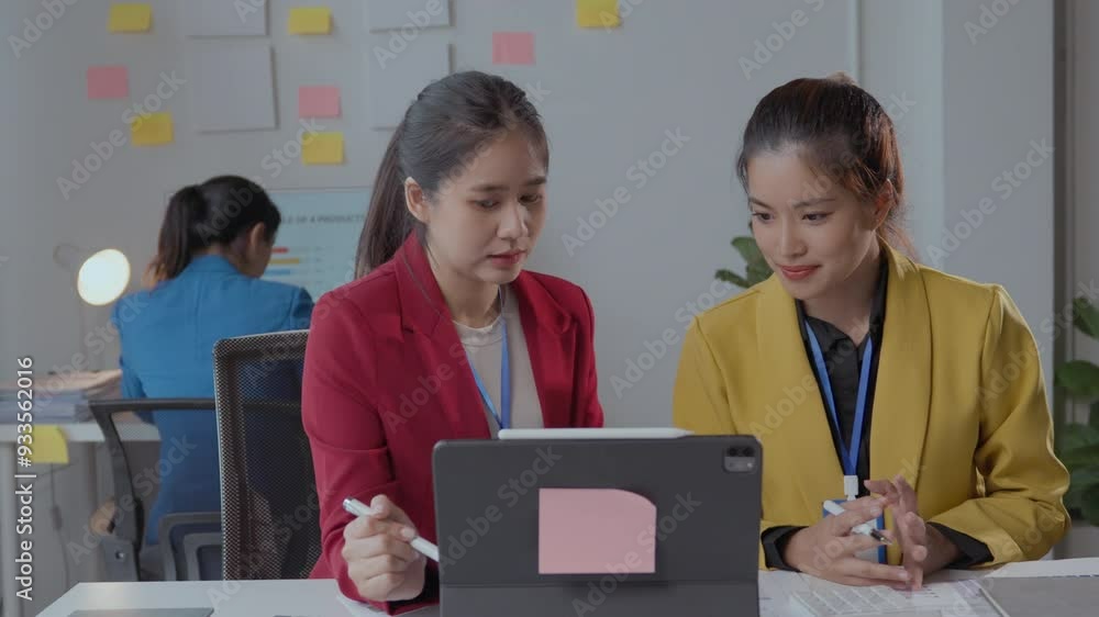 Poster two businesswomen engage in a productive working session, discussing ideas while using a tablet and 