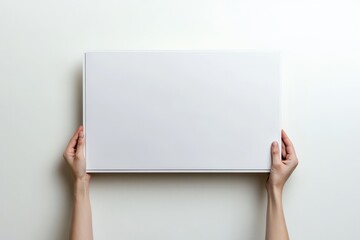 Hands holding a blank white rectangle, against a white background.