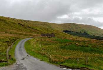 Ruins of an old school in the Gleniff Valley in the dartry Mountains with a road leading up to it