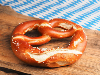Tasty Bavarian pretzel on a wooden board, Traditional German food