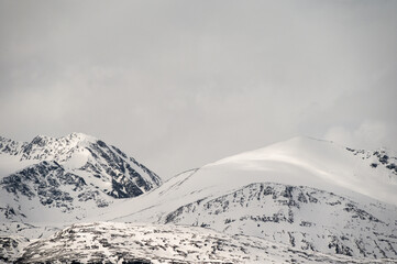 snowy landscape with snow-covered mountains along the road from Alta to Tromsoe, Norway