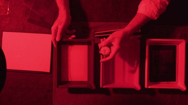vintage photographer developing film in a darkroom