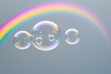 Soap bubbles and rainbow on a gray background