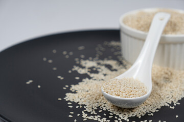 White roasted sesame seeds in a spoon