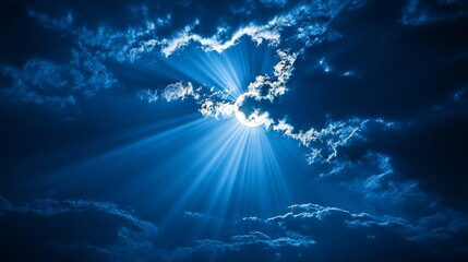 A moonlit night. Thin clouds obscure most of the moon, but rays of light shine through.