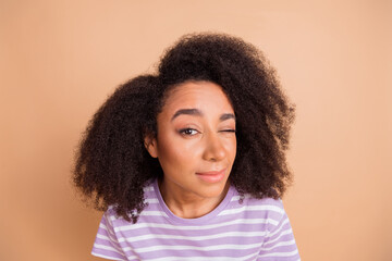 Photo of nice young woman eye look watch wear striped t-shirt isolated on beige color background