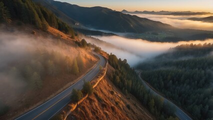 Winding Road Through Foggy Mountain Landscape at Sunset
