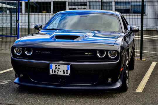 Roche-la-Moli&egrave;re, France - July 2nd 2023 : Car show. Side view on a black Dodge challenger srt hellcat widebody.