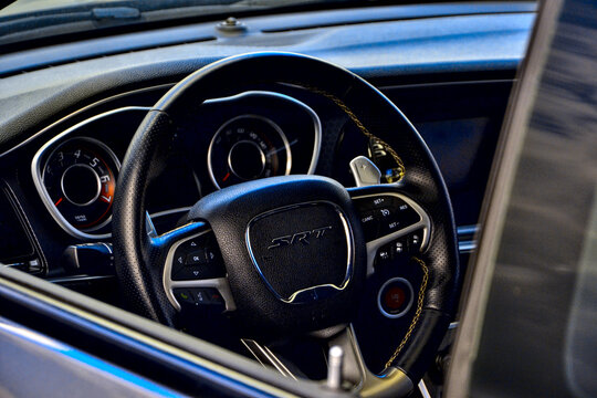 Roche-la-Moli&egrave;re, France - July 2nd 2023 : Car show. Focus on the steering wheel of a black Dodge challenger srt hellcat widebody.