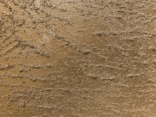 Texture of artistic plaster bronze colors. Abstract art stucco brown background with pattern, macro.