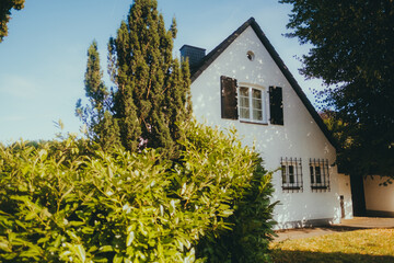 Beautiful European house exterior with green vegetation , European architecture 