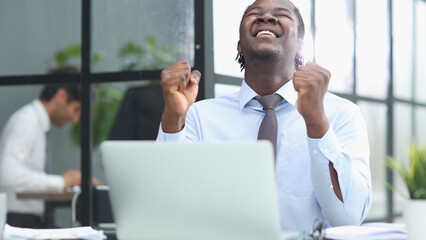 happy man working in the office. raised his hands joyfully