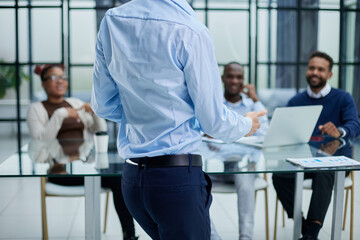 Young employee asking for advice from his helpful experienced colleagues in the office